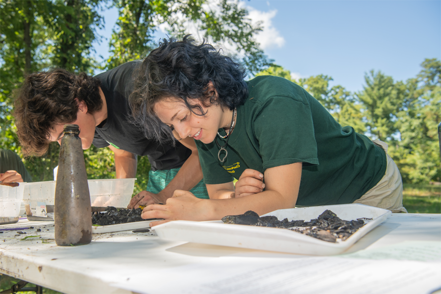 Two students working on a project outside for the Beacon Institute. 