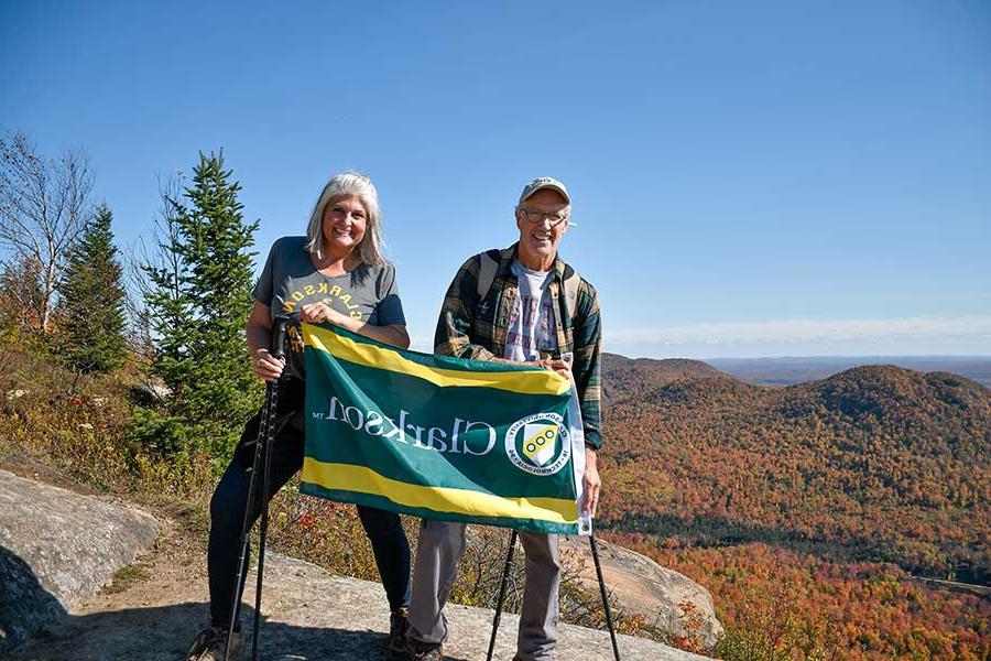 Couple hiking Azure Mountain showing their Clarkson Pride